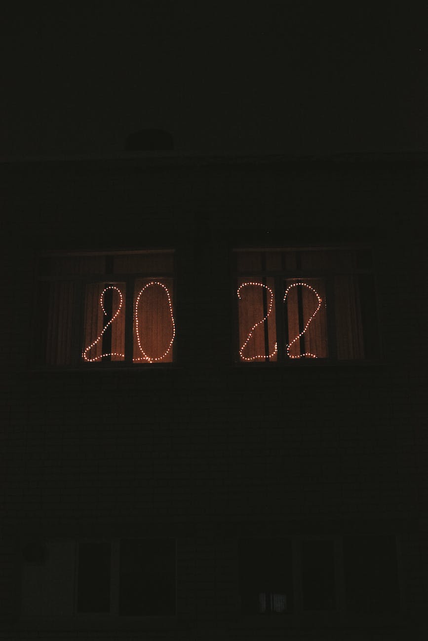 image shows the numbers 2022 formed out of glowing lights in a window