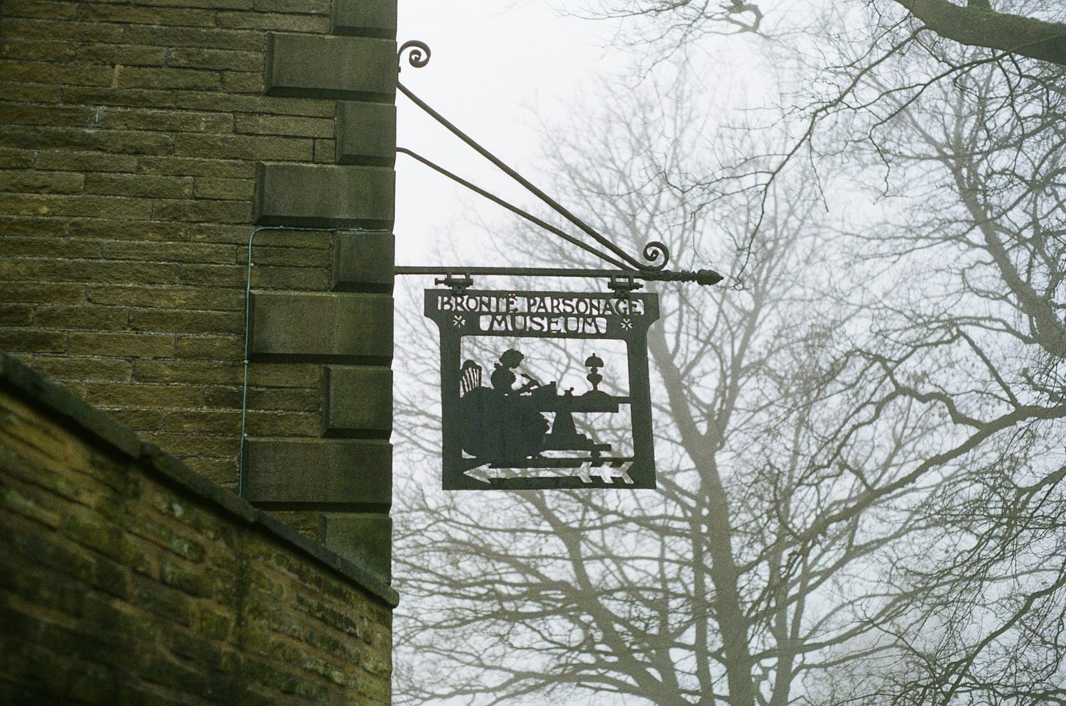 A metal silhouette sign that reads Bronte Parsonage Museum